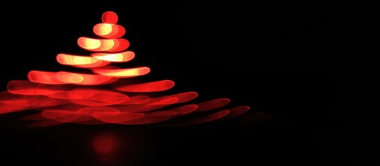 Poster - Red Christmas tree bokeh lights against a black background creating a festive and magical holiday atmosphere for seasonal designs.