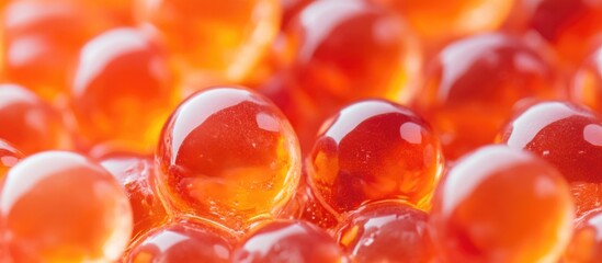 Poster - Bright salmon-colored hydrogel balls in transparent water creating a fresh and colorful macro background.