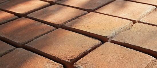 Poster - Red brick tiles arranged in a geometric pattern showcasing durability and versatility in construction and design applications