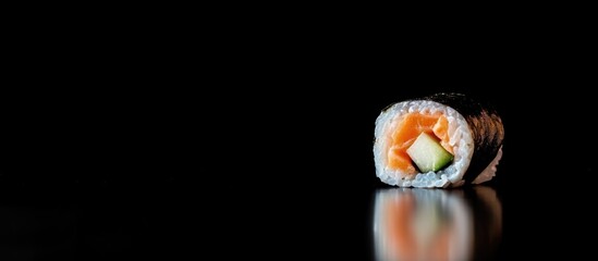 Aufkleber - Salmon sushi roll with carrot and cucumber on a reflective surface isolated on black background with space for text