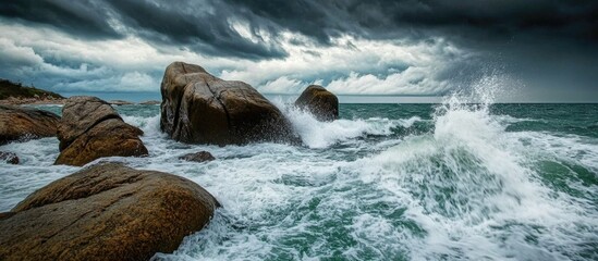 Poster - Dramatic ocean waves crashing against rocky coastline under dark stormy sky natural landscape image