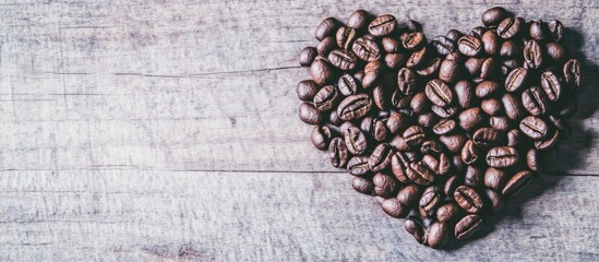 Aufkleber - Roasted coffee beans arranged in a heart shape on rustic wooden background symbolizing love for coffee and passion for flavors.