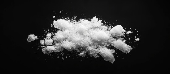 Poster - Sea salt crystals scattered against a sleek black background highlighting texture and contrast.