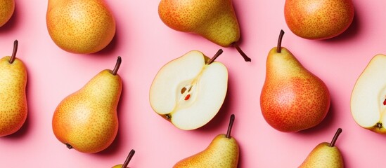 Aufkleber - Scattered ripe pears with one sliced in half on a pink background showcasing fresh juicy textures and natural simplicity of the fruit