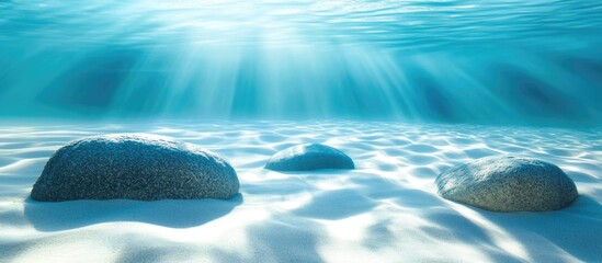 Aufkleber - Tranquil underwater scene featuring smooth rocks beneath clear turquoise water illuminated by soft sunlight rays.