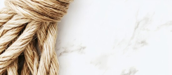 Poster - Natural twine cord roll on a textured background showcasing the rustic appeal of jute for crafts and design projects.