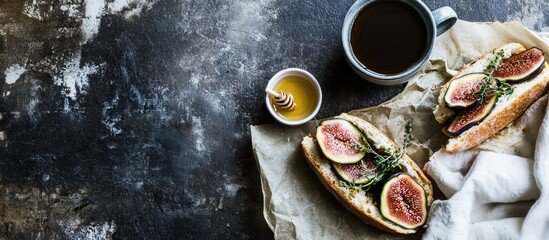 Poster - Breakfast sandwich with figs and thyme beside coffee and honey on a textured surface with a linen napkin in vertical composition