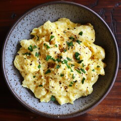Poster - Scrambled Eggs with Fresh Herbs in a Rustic Bowl Delicious Breakfast Option for a Wholesome Start to Your Day Nutritious Comfort Food