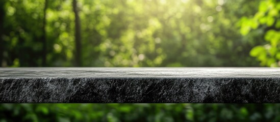 Sticker - Grey stone tabletop with blurred green background ideal for product display and marketing showcasing empty space for text and branding.