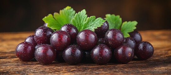 Canvas Print - Fresh black currants arranged on rustic wooden surface with rich textures and green leaves, showcasing their vibrant color and natural appeal.