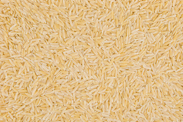 uncooked orzo pasta background,  rice shaped pasta, top view