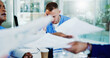 © peopleimages.com - Frustrated man, nurse and documents with headache for pressure, overworked stress or anxiety at busy hospital. Male person, doctor or healthcare worker with migraine, paperwork or chaos at clinic
