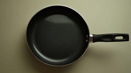 Poster - A close-up shot of a frying pan with a handle on a table, ready for use