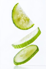 Poster - A slice of fresh cucumber falls through the air