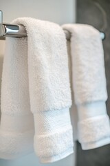 Poster - A pair of white towels hung on a simple towel rack, ready for use