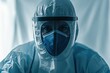 © Ahmed - Surgeon in full protective gear preparing for an operation, dark blue scrubs against a sterile white background for contrast