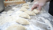 © Lailatul - Handmade dumplings preparation at a restaurant dough being molded on a floury table, for cooking oriental cuisine