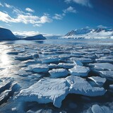 Expansive Arctic landscape features drifting ice floes and picturesque mountains under a clear blue sky