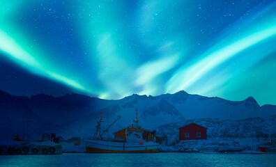 Wall Mural - northern lights in the sky over the city of tromso, in northern norway, above the harbor ships durin
