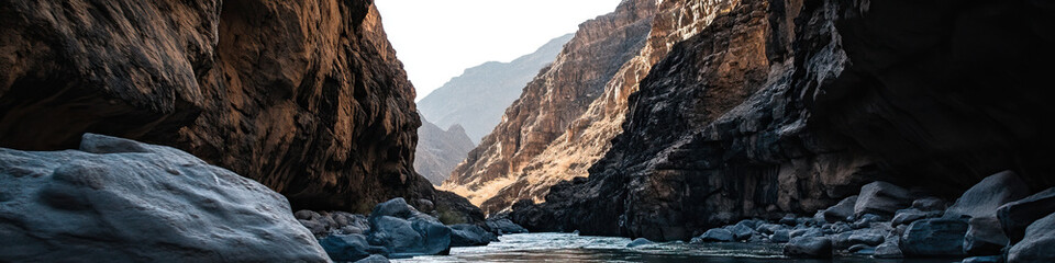 Wall Mural - River Canyon with Dark Rock Walls and Boulders