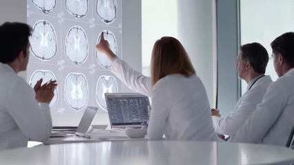 Aufkleber - Doctors and healthcare professionals discuss a series of brain scans displayed on a large screen, pointing and gesturing as they analyze medical images in slow motion