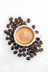 Wall Mural - Top view white cup of coffee with coffee beans scattered around it on a white background