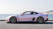 © arazka - Pink Sports Car Parked by the Ocean on a Sunny Day