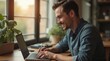 © Таня Андреева - Man freelancer working on laptop, natural light, cozy indoor setting