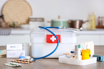 Poster - Home first aid kit with medications on table in kitchen, closeup