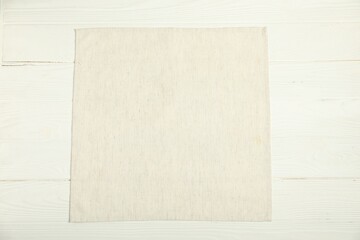 Wall Mural - Light napkin on white wooden table, top view