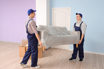 Wall Mural - Loaders carrying grey sofa in room