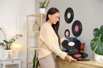 Wall Mural - Beautiful woman with vinyl disks for record player in bedroom