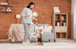 © Pixel-Shot - Pretty young woman with treat training her cute Beagle dog at home