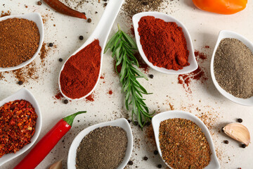 Composition with bowls of different fresh spices on light background