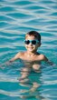 © akkash vertical - child sea a swims sunglasses children sea summer beach fun happy vacation children girl sunglasses water holiday lifestyle leisure pool caucasian happiness sun people little joy travel blue childhood