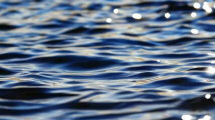 Poster - Rippling water surface reflecting sunlight, serene aquatic scene concept