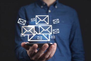 Poster - Glowing Email Notifications: Smartphone Communication Concept. Person holding phone with multiple email icons floating, symbolizing digital messaging,