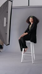 Poster - Woman, model or photoshoot with photographer for fashion catalog or magazine at studio. Female person, videographer or client posing with style on set for picture, digital marketing or production