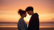 © NaphakStudio - couple sharing romantic moment at sunset on beach, silhouetted against colorful sky