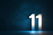 © Abdul - A pearl white number 11 on a deep indigo background, softly illuminated with a hint of shadow for depth.