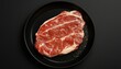 © Montalumirock - Beef slice on black pan plate for cooking dinner