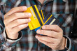© Media  - man holding credit cards and he is choosing a credit card to pay and spend Payment for goods via credit card. Finance and banking concept