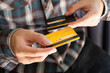 © Media  - man holding credit cards and he is choosing a credit card to pay and spend Payment for goods via credit card. Finance and banking concep