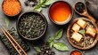 © AFFANYUDA - Asian tea, fish, and snack ingredients on a dark stone surface