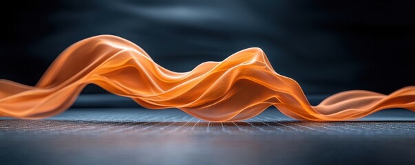 Poster - A flowing orange fabric drapes elegantly against a dark background, creating a sense of movement and softness.