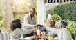 © peopleimages.com - Family, toast and outdoor dining table for celebration on vacation, easter lunch and proud to connect. Old people, cheers and share traditional holiday in garden, social gathering and patio party