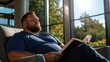 © Formoney - A plus-sized man enjoying a quiet afternoon at a local library, reading a book in a comfortable chair.