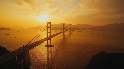 Poster - A panoramic aerial view of a long bridge spanning across the ocean at sunset, with golden skies and calm waters enhancing the beauty of the moment