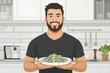 © Julia - Man smiling while holding plate of low-carb pasta alternatives, promoting low-carbohydrate diet and weight loss. Concept embraces low-carbohydrate diet for healthier eating choices