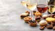 © Chanwit - Table set with wine cookies desserts and close-up of dessert pairing with white wine on a wooden surface